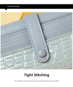 Detail showing high-quality stitching on light blue leather with faux crocodile texture