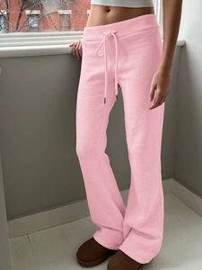 Detail view of pink cotton blend yoga pants with adjustable drawstring waist tie