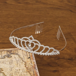 Elegant rhinestone crown tiara with heart motifs and metal hair comb for bridal styling