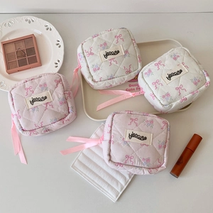 Flat lay of mini quilted floral pouches with cute pink ribbon zippers and bows