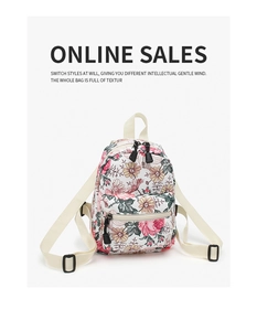 Close-up of floral mini canvas backpack featuring a cream base with colorful flower patterns