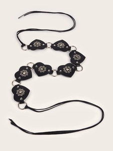 Detail of black heart-shaped belt with silver metal rings and rivet studs decoration