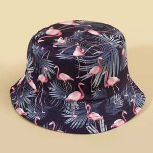 Reversible bucket hat with flamingo and palm leaf print on dark blue fabric