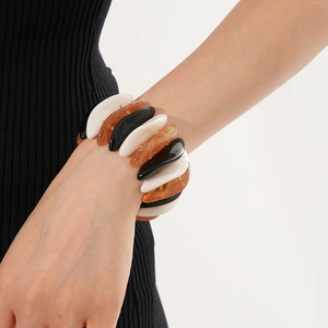 Detailed view of elastic chunky resin bracelet in black white and amber tortoise shell
