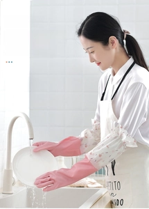 Pink waterproof latex kitchen gloves with floral cuffs used for washing dishes