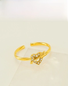 Detail of 18k gold plated stainless steel heart and arrow ring with zircon inlay