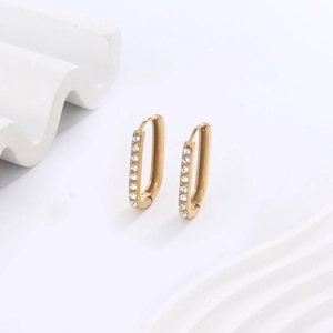Detail view of gold-plated rectangular earrings with double-row micro-paved zircons