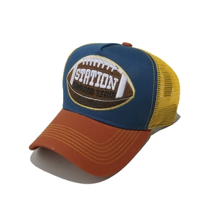 Close-up of rugby team embroidery on a contrast color mesh trucker hat with flat peak