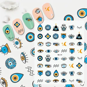 Detail of bohemian evil eye nail art stickers featuring blue eye and hamsa patterns