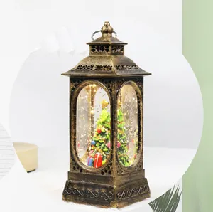 Detail of vintage Christmas lantern with bronze finish, glowing LED tree, and glitter snow