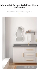 Irregular cloud-shaped mirror with white wavy frame on a minimalist bathroom vanity