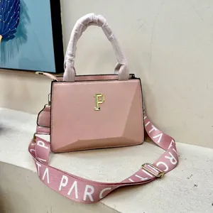 Detailed close-up of pink geometric tote bag with gold P logo and wide stylish strap