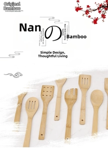 Detailed view of natural bamboo cooking utensil set with slotted spatulas and hanging holes