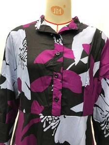 Detail of floral digital print on black A-line dress with buttons and turn-down collar