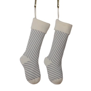 Knitted Christmas stockings with grey and white stripes for holiday gift decoration