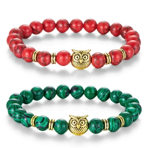 Close-up of beaded agate owl bracelets in red and green stone with golden charms
