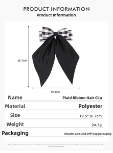 Detail view of plaid ribbon hair clip showing material texture and size dimensions