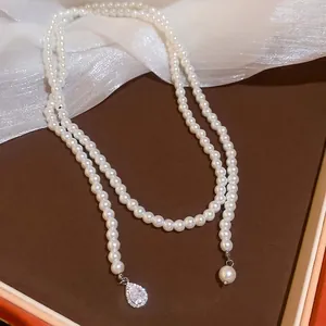 Elegant pearl bead necklace with a water drop crystal pendant on brown leather base
