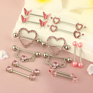 Pink heart and butterfly nipple rings set in polished stainless steel on white steps