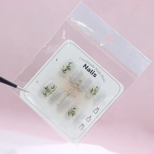 Cat-eye press-on nails with hand-painted green bamboo leaves on elegant grey base