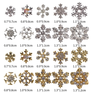 Detailed grid of snowflake nail charms in gold and silver alloy with crystal rhinestones