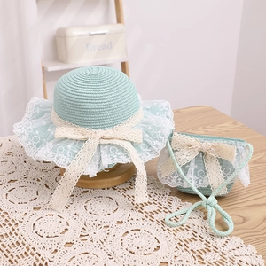 Close-up of mint green woven straw hat and bag set with white lace and bow detailing