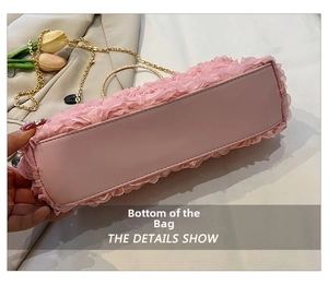Detailed close-up of pink petal clutch bag showing high-quality leather base and gold chain