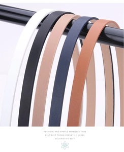 Collection of six slim fashion belts in various colors displayed on a sleek black rack