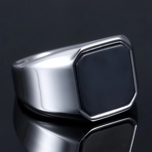 Macro shot of silver stainless steel signet ring with black octagonal stone inlay