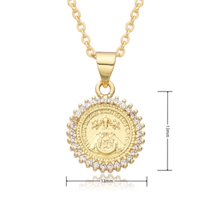 Macro view of 13mm gold religious coin pendant with sparkling white zircon crystals