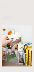 Detailed view of transparent clip organizer for refrigerator door storage and bag sorting