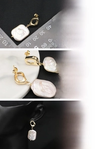 Detail of baroque freshwater pearl earrings with 18K gold plating on black model