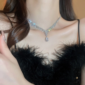 Macro shot of silver-tone teardrop pendant necklace with sparkling crystal rhinestones