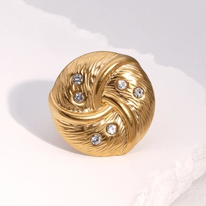 Macro shot of 18k gold plated ring with feather texture and inlaid white zircons
