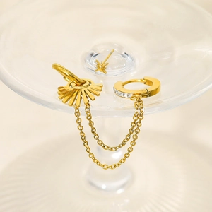 18K gold plated star earring and chain cuff set with sparkling zircon on glass surface