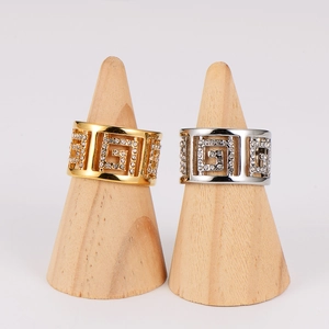 Exquisite sparkling rhinestone rings in gold and silver finish on wooden stands