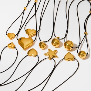 Minimalist wax cord necklace featuring gold stainless steel heart and star pendants
