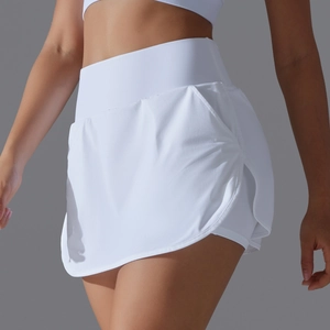 Close-up of white high-waisted tennis skort with side slit and built-in shorts