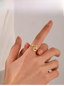 Detail shot of a double-layered 18K gold-plated heart ring with woven texture