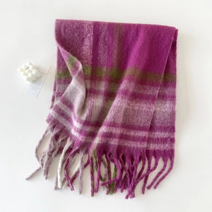 Detail of pink, purple, and green plaid mohair scarf with soft fringe texture and tassels