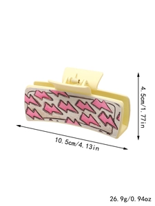 Detailed size and weight specs for yellow leather cactus hair claw with pink lightning bolt