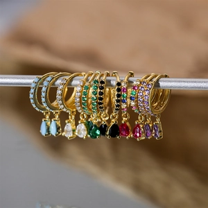 Macro shot of S925 silver gold-plated hoop earrings with colorful pear-cut crystal drops