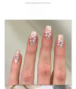 Close-up of shimmer pearl short ballet fake nails with 3D pink flowers and rhinestones