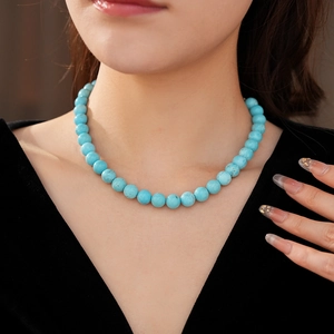 Close-up of minimalist turquoise beaded necklace on neck showcasing elegant blue stones