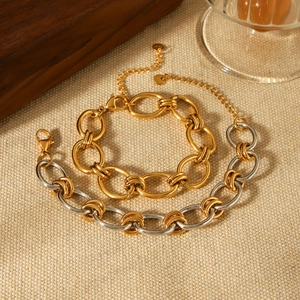 Bracelet à maillons bicolores en acier inoxydable or et argent sur lin tissé