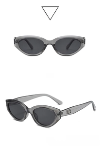 Detailed front and side view of cat-eye sunglasses with transparent grey frame and B-logo