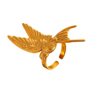 Detailed close-up of 18K gold-plated flying bird wings on a minimalist open ring band