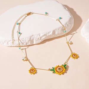 Detail of sunflower and bee necklace with enamel petals and turquoise bead accents