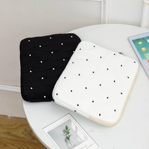 Detailed view of quilted polka dot laptop sleeve with soft padded protective fabric