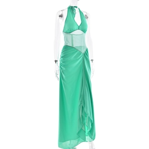 Detailed view of mint green halter neck dress featuring waist cutouts and irregular hemline